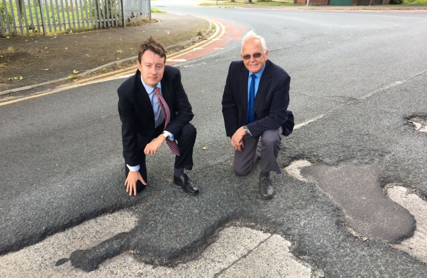 Simon Clarke MP & Cllr Cliff Foggo inspecting potholes